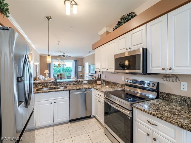 kitchen with white cabinets, sink, ceiling fan, light tile patterned floors, and appliances with stainless steel finishes