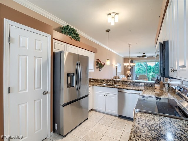 kitchen with light tile patterned floors, stainless steel appliances, white cabinetry, and ceiling fan