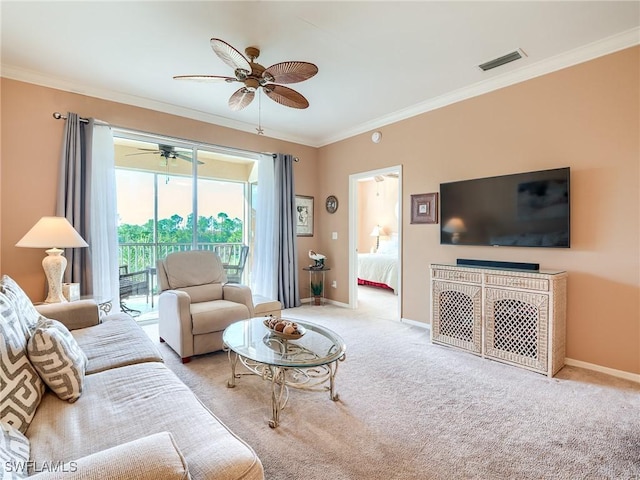 carpeted living room featuring ceiling fan and ornamental molding