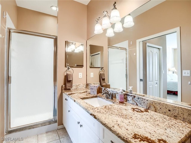 bathroom featuring tile patterned floors, vanity, an enclosed shower, and a chandelier