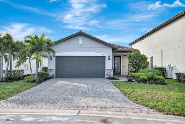 view of front facade with a garage and a front lawn