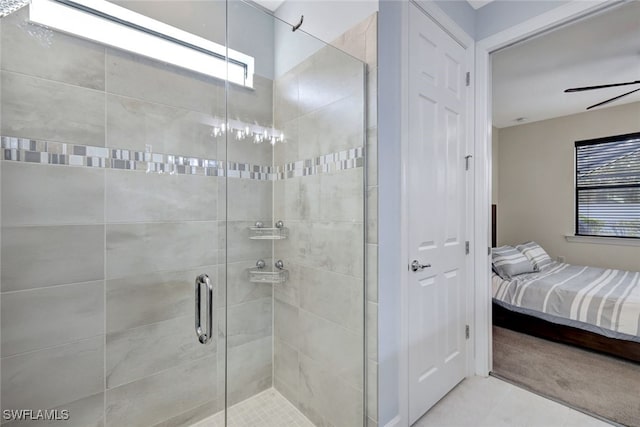 bathroom featuring tile patterned flooring, a shower with door, and ceiling fan