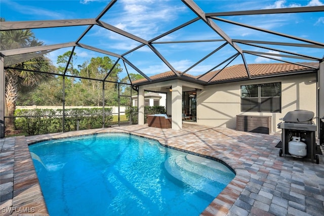 view of swimming pool featuring ceiling fan, a lanai, and a patio