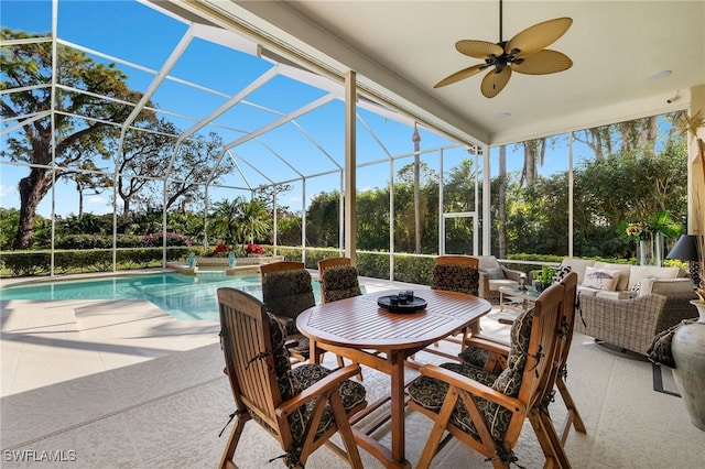 exterior space featuring outdoor lounge area, glass enclosure, ceiling fan, and a patio area