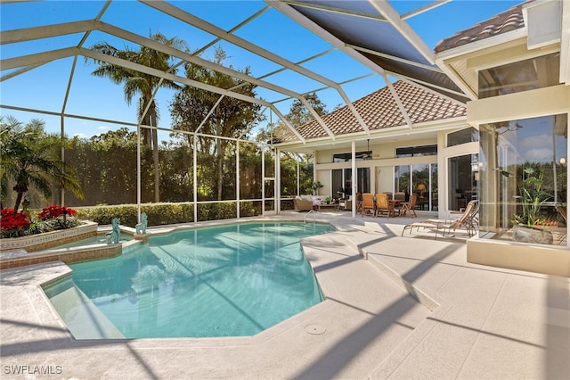 view of pool with ceiling fan, a lanai, and a patio