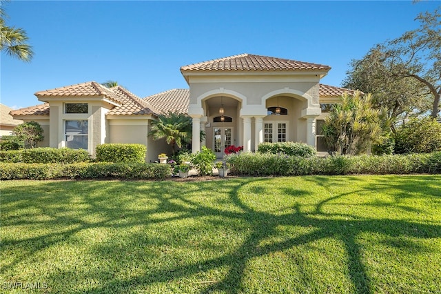 24991 Goldcrest Dr, Bonita Springs, FL 34134 - mediterranean / spanish-style house with a front lawn