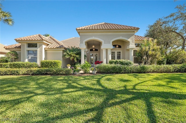 mediterranean / spanish-style house with a front lawn