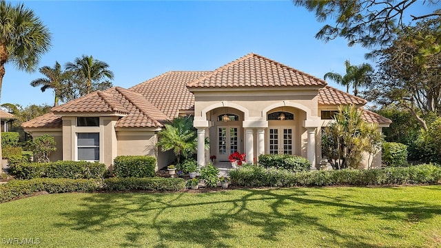 mediterranean / spanish-style home with a front lawn