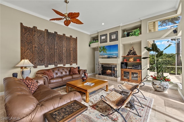 living room with built in shelves, ceiling fan, and ornamental molding