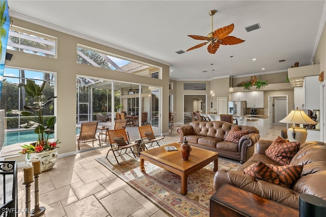 living room featuring ceiling fan and ornamental molding