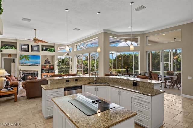 kitchen featuring a center island, white cabinetry, and sink