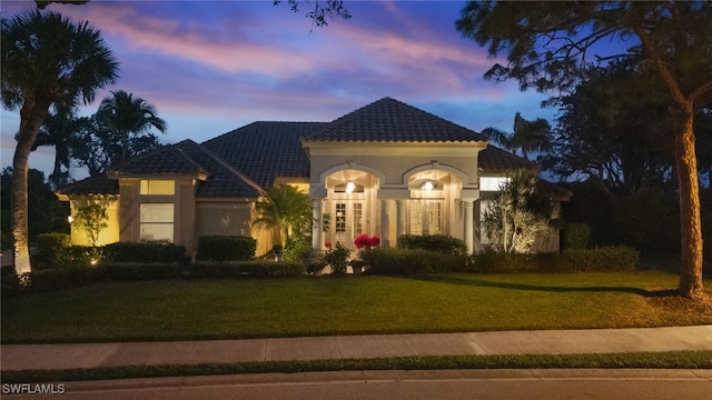 mediterranean / spanish-style house featuring a yard