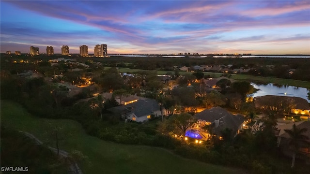 aerial view at dusk with a water view