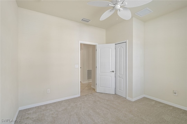 carpeted spare room featuring ceiling fan