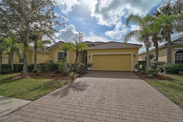 view of front facade featuring a garage and a front lawn