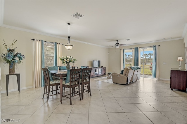 dining area featuring a wealth of natural light, ornamental molding, and light tile patterned flooring