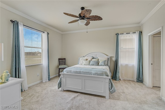 carpeted bedroom with ceiling fan and crown molding