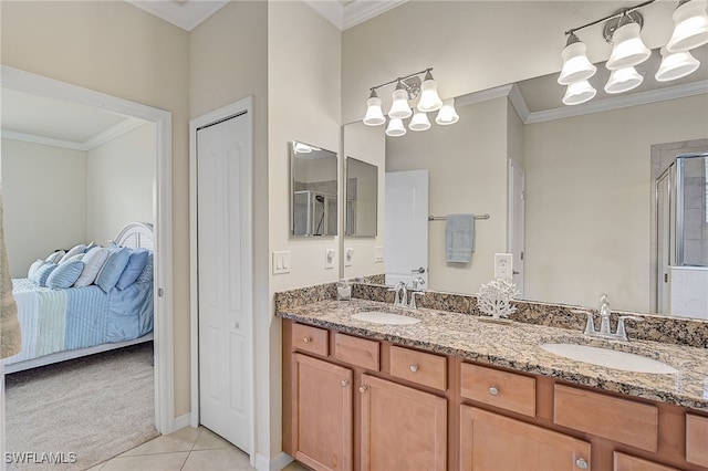 bathroom featuring tile patterned flooring, vanity, a shower with door, and ornamental molding