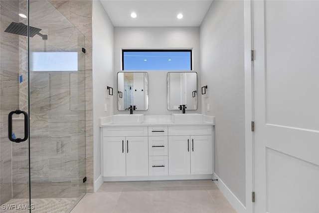 bathroom featuring double vanity, a wealth of natural light, a shower stall, and a sink