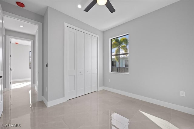 unfurnished bedroom featuring recessed lighting, a closet, and baseboards