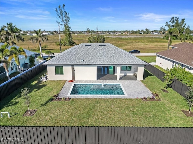 back of property with a yard, a patio area, a fenced backyard, and stucco siding