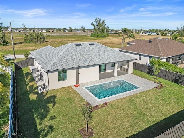 view of pool featuring a yard, a fenced backyard, a fenced in pool, and a patio