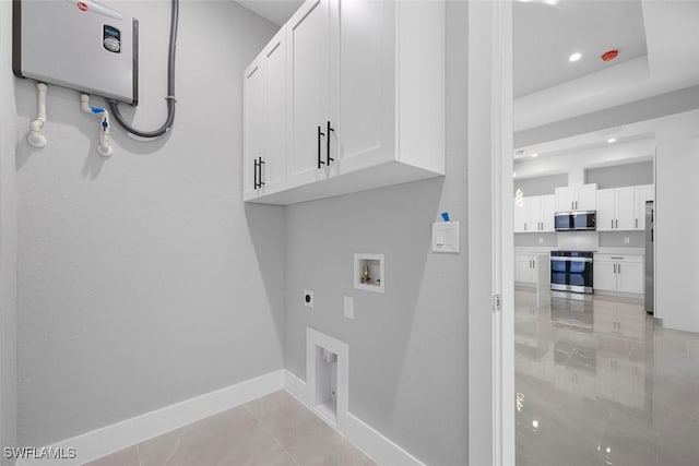 clothes washing area with washer hookup, light tile patterned floors, cabinet space, hookup for an electric dryer, and baseboards