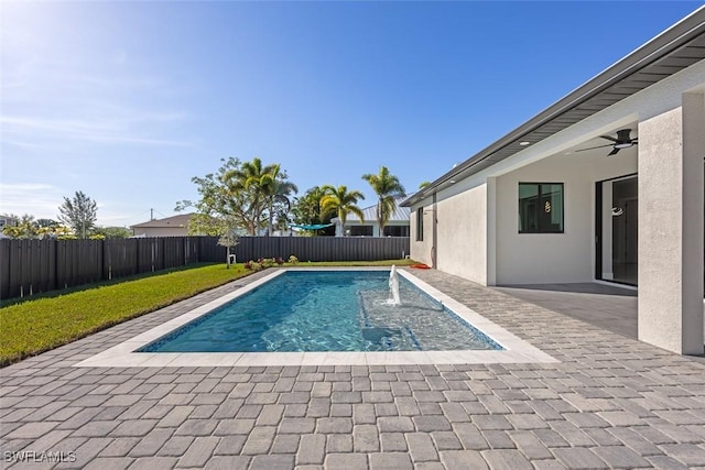 view of pool featuring a patio area, a fenced backyard, a ceiling fan, and a fenced in pool