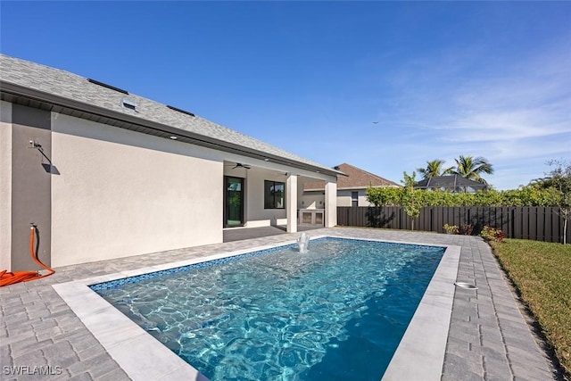 view of pool with a patio area, a fenced backyard, a fenced in pool, and a ceiling fan