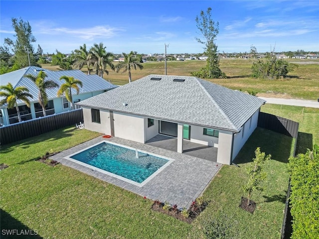 rear view of house featuring a patio area, a fenced backyard, stucco siding, and a yard