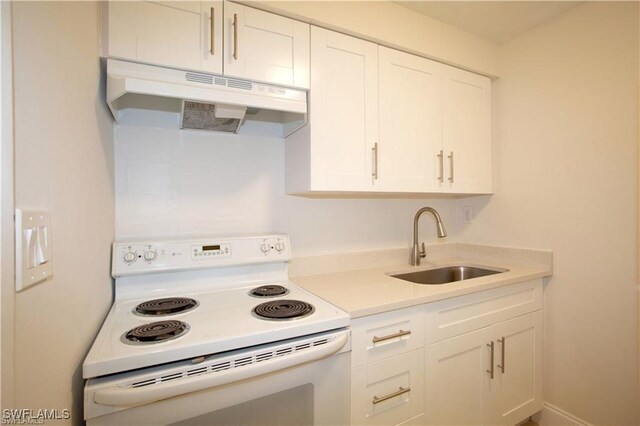 kitchen featuring white range with electric stovetop, white cabinetry, and sink