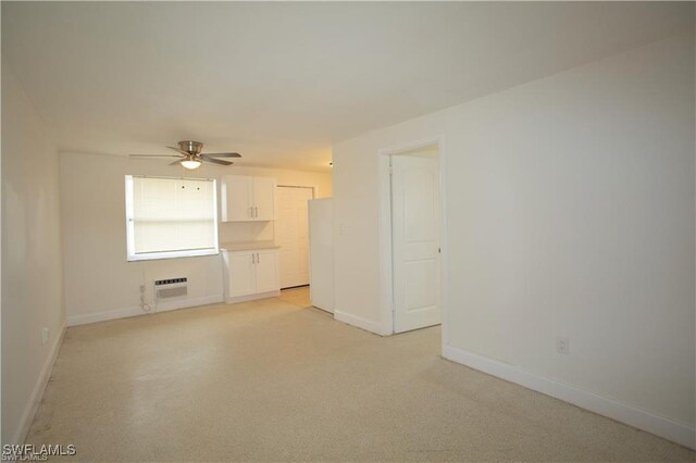 empty room with a wall mounted AC and ceiling fan