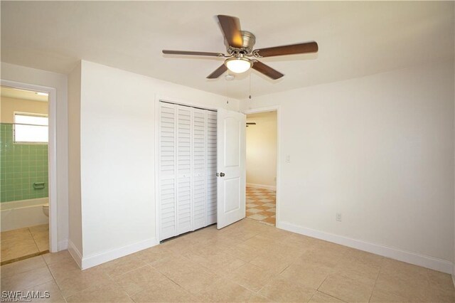 unfurnished bedroom with connected bathroom, ceiling fan, a closet, and light tile patterned flooring