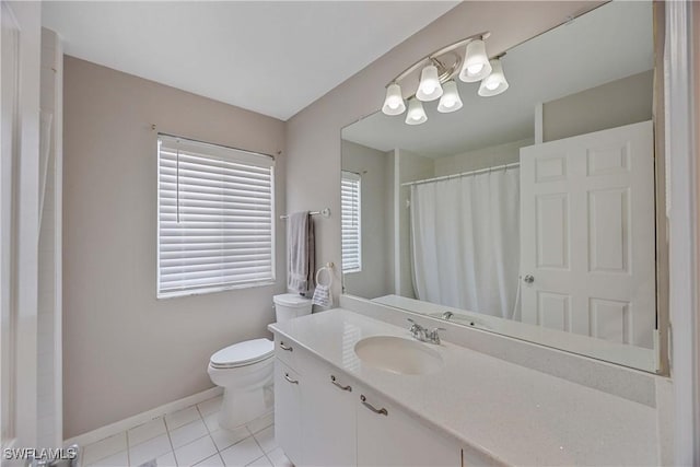 bathroom featuring tile patterned floors, vanity, and toilet