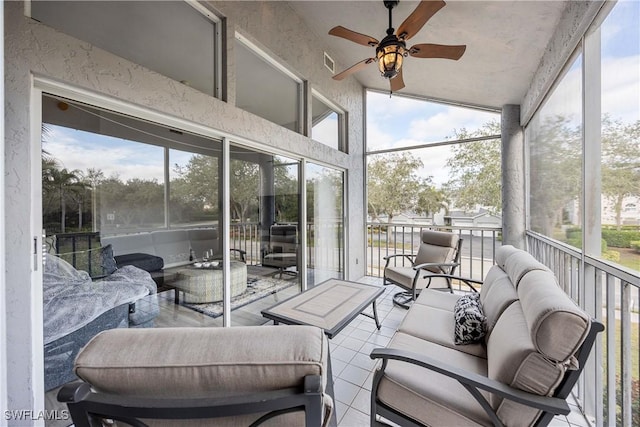 sunroom featuring ceiling fan