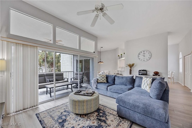 living room with light wood-type flooring and ceiling fan