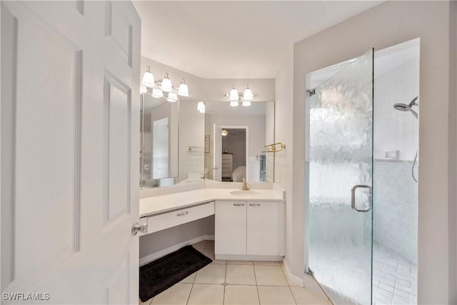 bathroom with tile patterned floors, vanity, and walk in shower