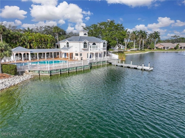 rear view of house with a water view and a patio