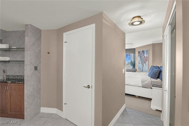 hall featuring light tile patterned flooring