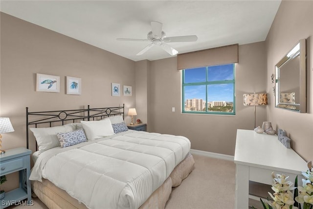 bedroom featuring ceiling fan and light carpet