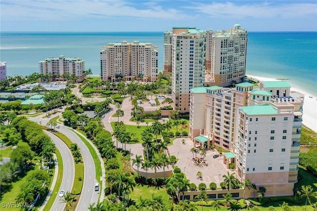 aerial view with a water view and a beach view