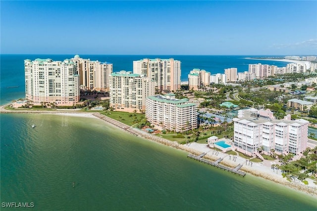 drone / aerial view featuring a water view and a view of the beach