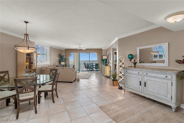 dining room with crown molding, light tile patterned floors, and ceiling fan