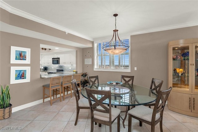 tiled dining room featuring ornamental molding