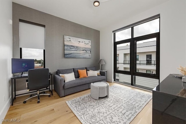 home office with light hardwood / wood-style flooring