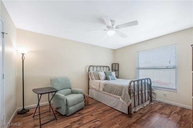 bedroom with ceiling fan and dark hardwood / wood-style floors