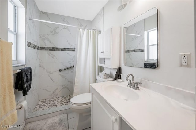 bathroom featuring a shower with curtain, toilet, and vanity