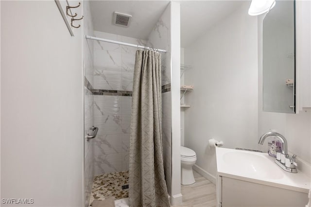 bathroom with vanity, curtained shower, and toilet