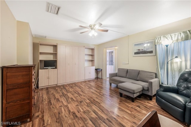 living room with ceiling fan and wood-type flooring