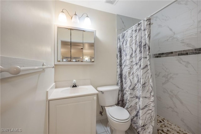 bathroom featuring tile patterned flooring, vanity, toilet, and curtained shower